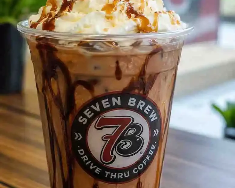 7 Brew German Chocolate recipe served as an iced coffee with whipped cream, chocolate drizzle, caramel, and toasted coconut