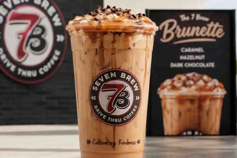 7 Brew Brunette iced coffee with caramel, hazelnut, and dark chocolate flavors topped with whipped cream in a branded clear cup.