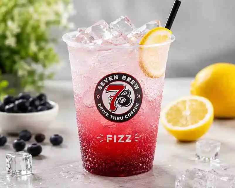 Colorful 7 Brew Fizz sparkling drinks featuring Blue Raspberry, Strawberry, Mango, Coconut, Cherry, Peach, and Kiwi flavors served over ice.